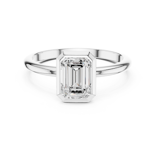 Bezel-set emerald engagement ring in 935 silver

White gold engagement ring featuring bezel emerald

Modern women’s ring with emerald-cut bezel-set gemstone