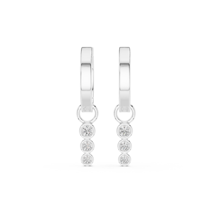 White gold huggie hoop earrings featuring a bezel-set three-diamond drop with round brilliant lab-grown diamonds