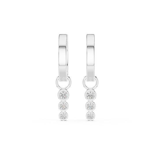 White gold huggie hoop earrings featuring a bezel-set three-diamond drop with round brilliant lab-grown diamonds