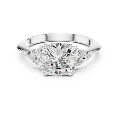 Three-stone engagement ring with cushion center diamond and two trillion side diamonds in white metal

Elegant cushion and trillion-cut diamond ring in 935 silver

Modern three-stone engagement ring featuring cushion center and trillion side diamonds