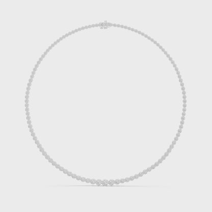 Diamond tennis necklace featuring continuous round brilliant-cut diamonds in polished metal