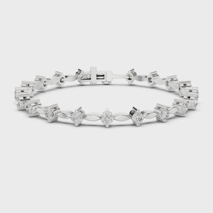 Alternating marquise and round diamond tennis bracelet with polished metal setting