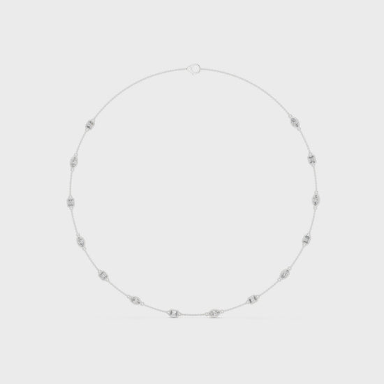 Pear and emerald-cut bezel setting necklace with polished metal chain and sparkling diamonds