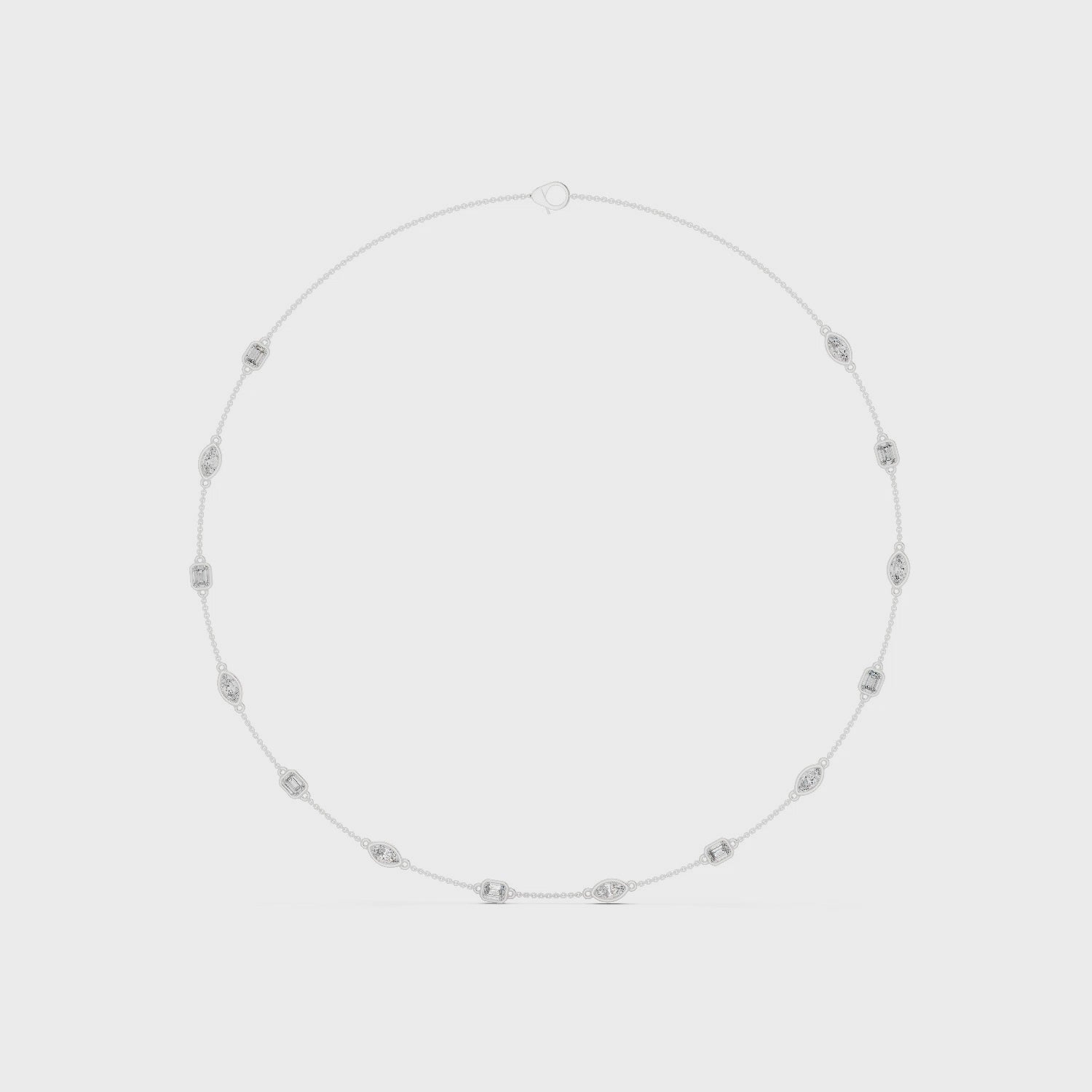 Pear and emerald-cut bezel setting necklace with polished metal chain and sparkling diamonds