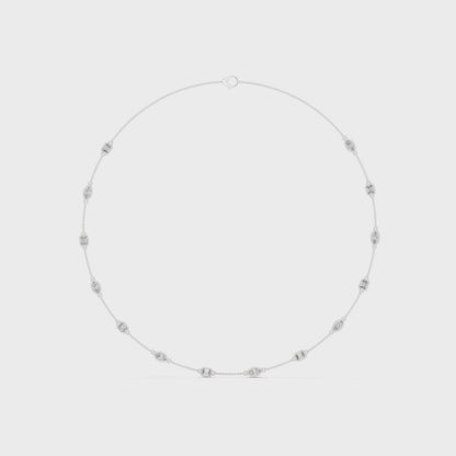 Pear and emerald-cut bezel setting necklace with polished metal chain and sparkling diamonds