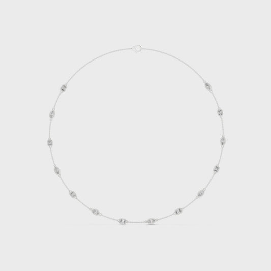 Pear and emerald-cut bezel setting necklace with polished metal chain and sparkling diamonds