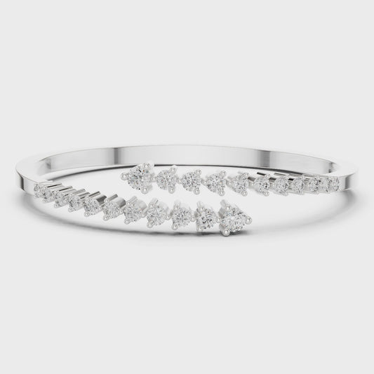 Diamond bypass bangle bracelet featuring round brilliant diamonds in polished metal
