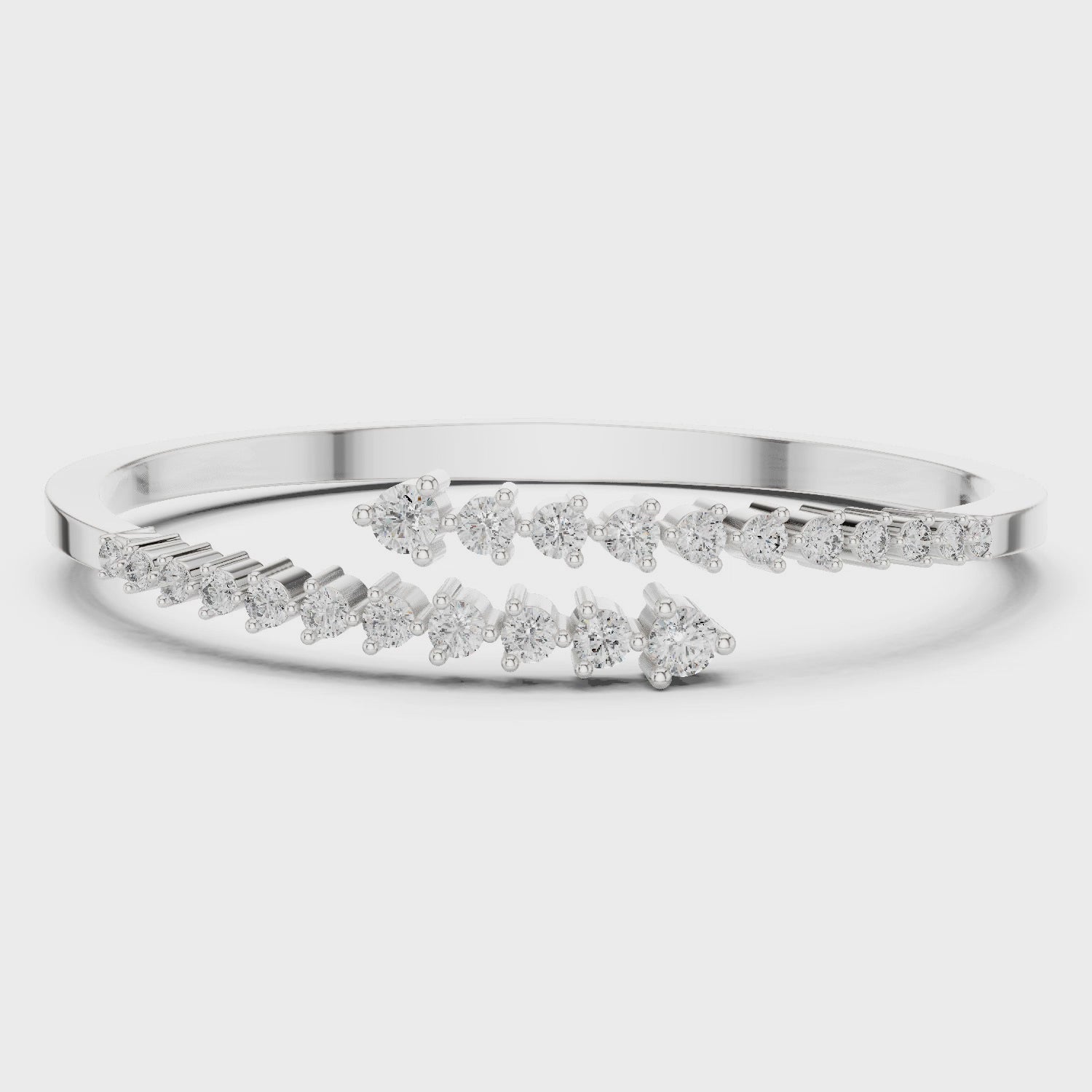 Diamond bypass bangle bracelet featuring round brilliant diamonds in polished metal