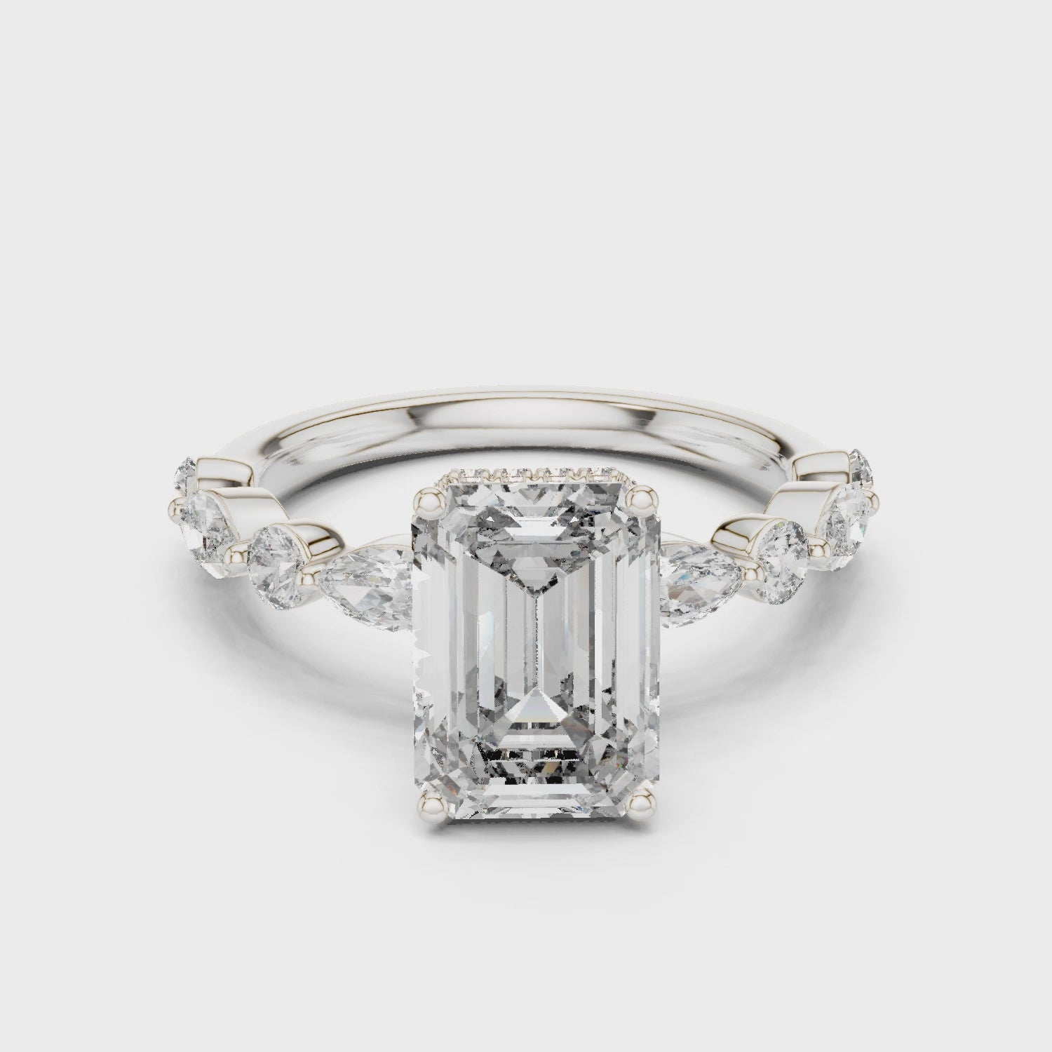 Emerald-cut lab-grown diamond engagement ring with floating round-cut side diamonds

Modern engagement ring with emerald-cut center and floating pavé accents

Elegant bridal ring featuring emerald center stone and floating diamonds