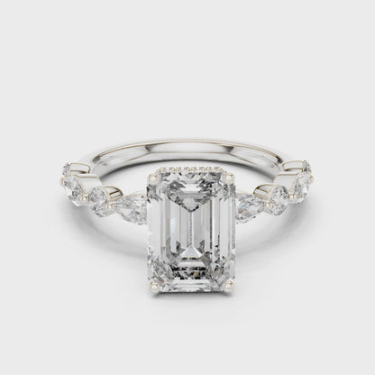 Emerald-cut lab-grown diamond engagement ring with floating round-cut side diamonds

Modern engagement ring with emerald-cut center and floating pavé accents

Elegant bridal ring featuring emerald center stone and floating diamonds