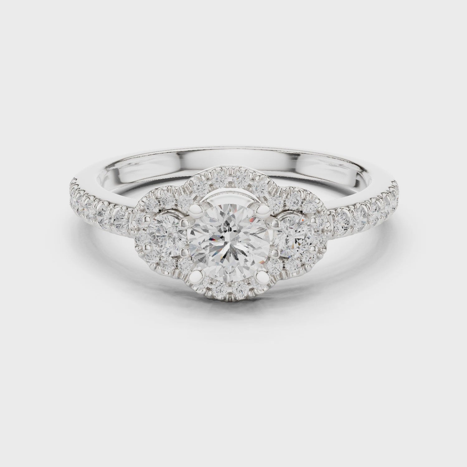 Halo three-stone lab-grown diamond engagement ring

Round-cut center stones with halo pavé diamonds

Elegant three-stone bridal engagement ring in white gold