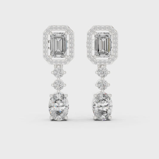 Emerald-cut drop halo dangler earrings with round diamond halo and polished metal finish