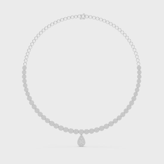 Round diamond necklace featuring a pear-shaped diamond centerpiece on polished metal