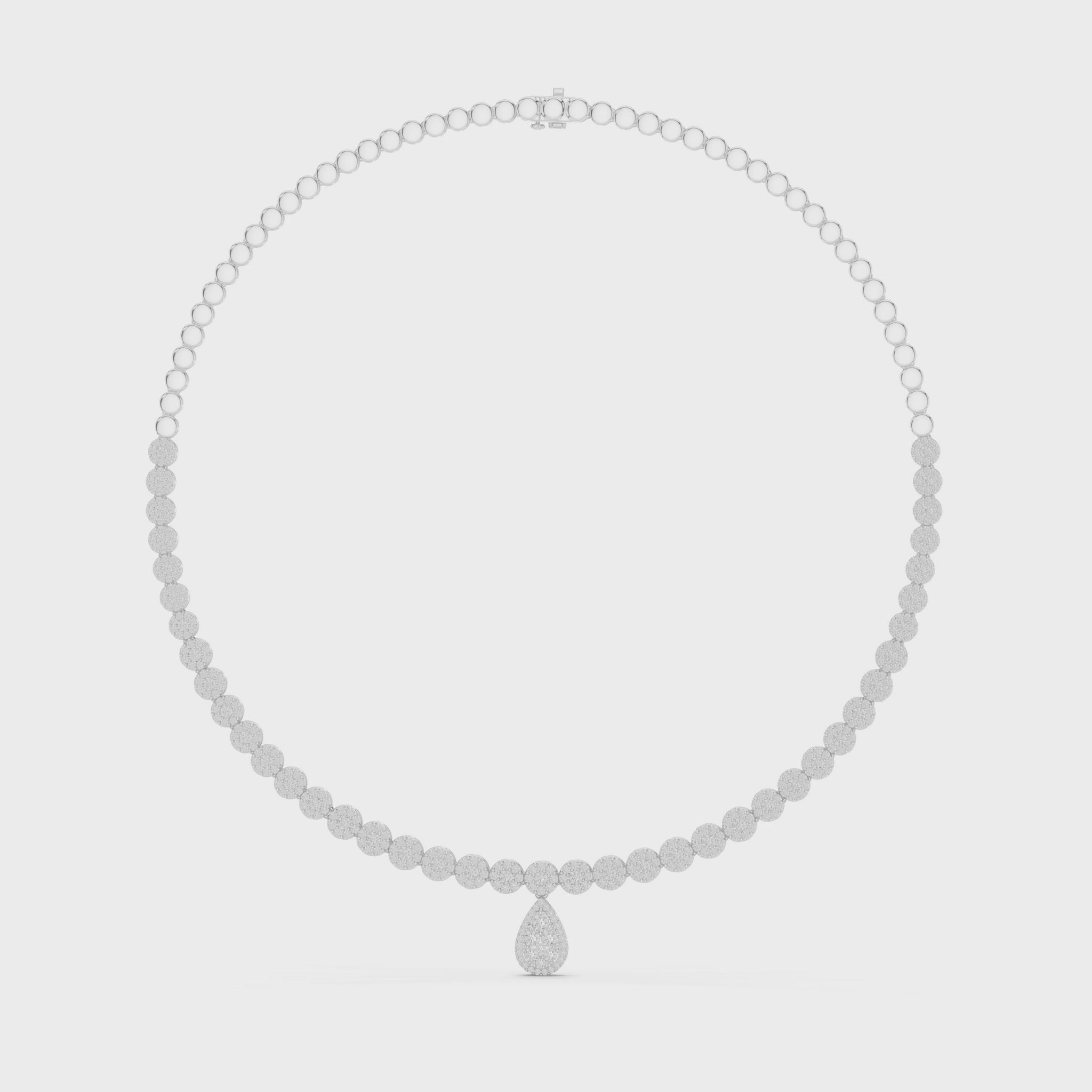 Round diamond necklace featuring a pear-shaped diamond centerpiece on polished metal