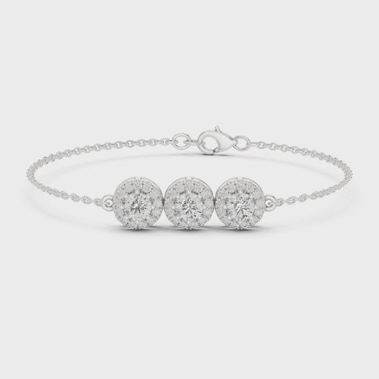 Diamond bracelet featuring three round diamond clusters in a polished metal finish