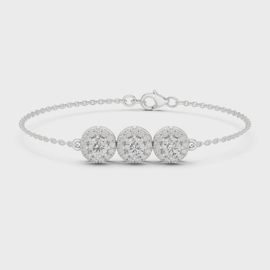 Diamond bracelet featuring three round diamond clusters in a polished metal finish