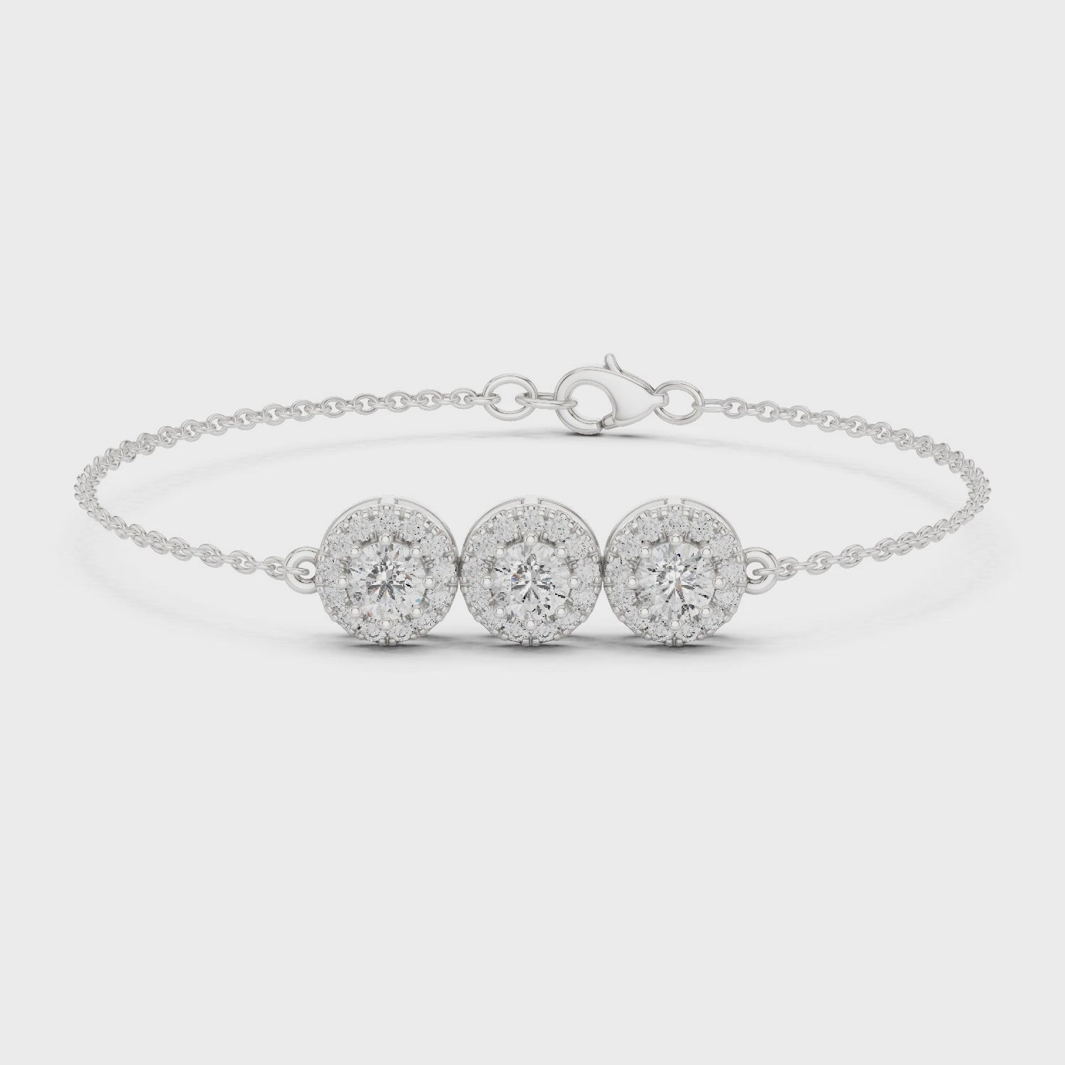 Diamond bracelet featuring three round diamond clusters in a polished metal finish