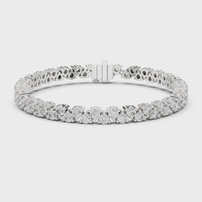 Diamond tennis bracelet with buttercup-set round diamonds in a polished metal finish