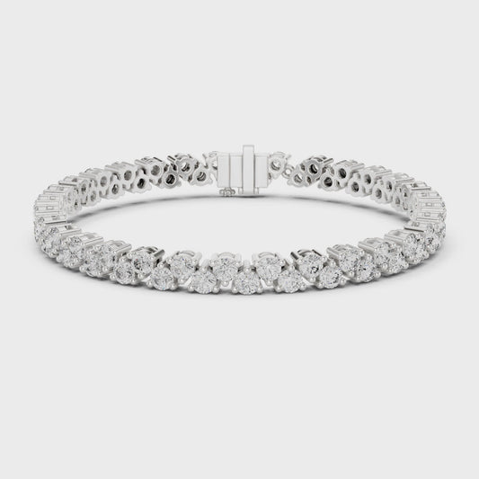 Diamond tennis bracelet with buttercup-set round diamonds in a polished metal finish