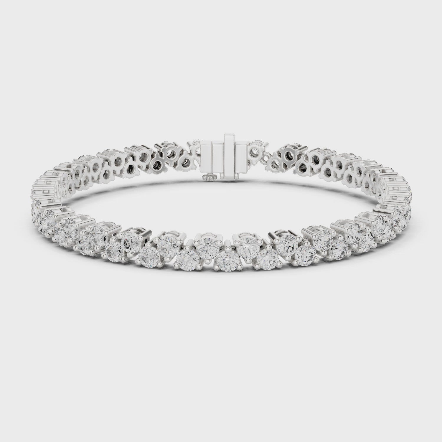 Diamond tennis bracelet with buttercup-set round diamonds in a polished metal finish